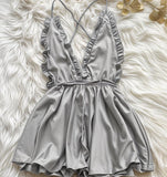 Jumpsuit made of satin with ruffles around the chest