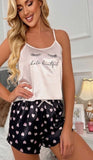 Two-piece satin pajamas - with hearts print on the shorts and eyelashes print on the top